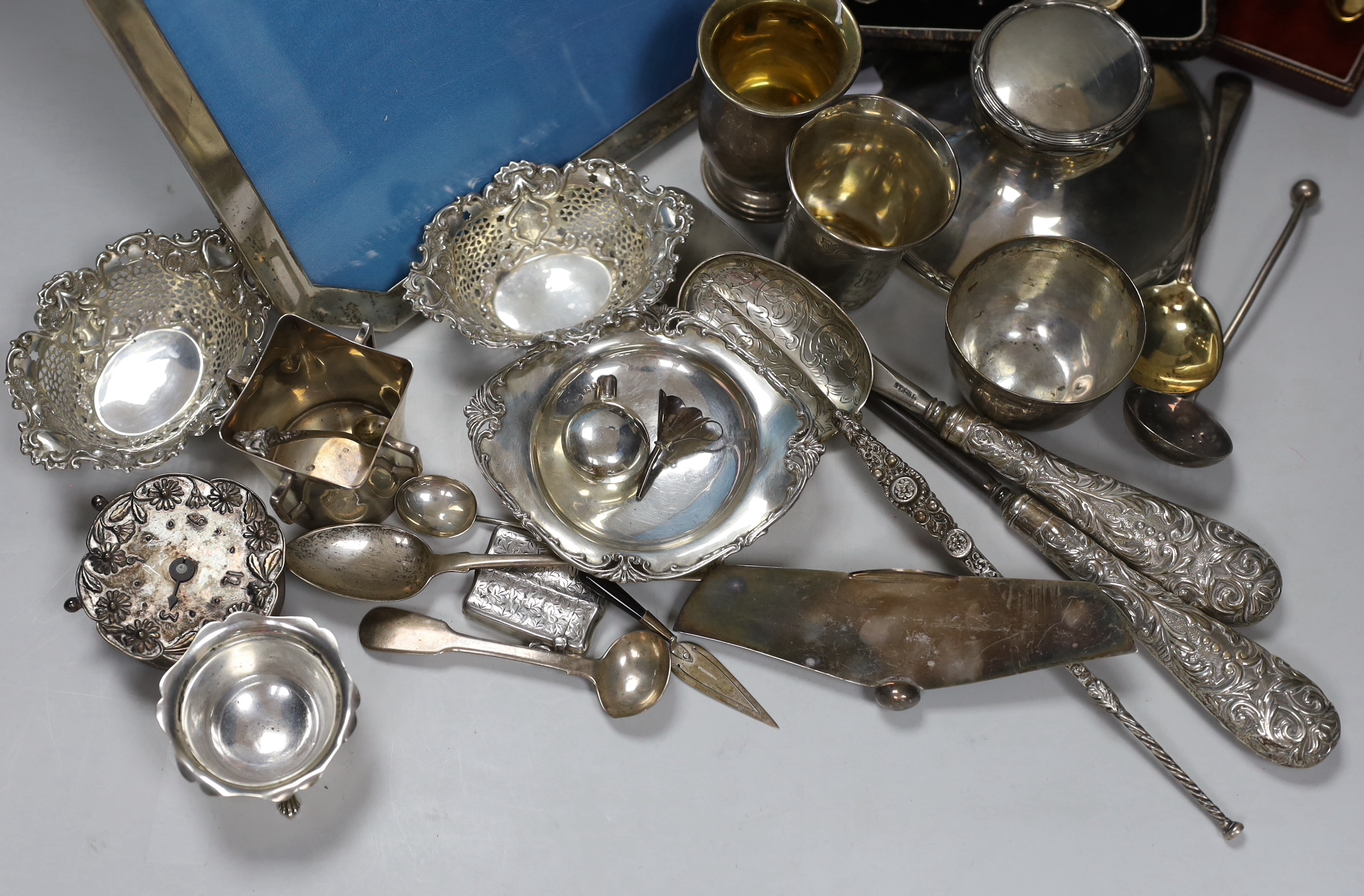 Assorted silver and white metal items including capstan inkwell, mug, photograph frame, cased and loose flatware, anointing spoon replica, beakers etc.